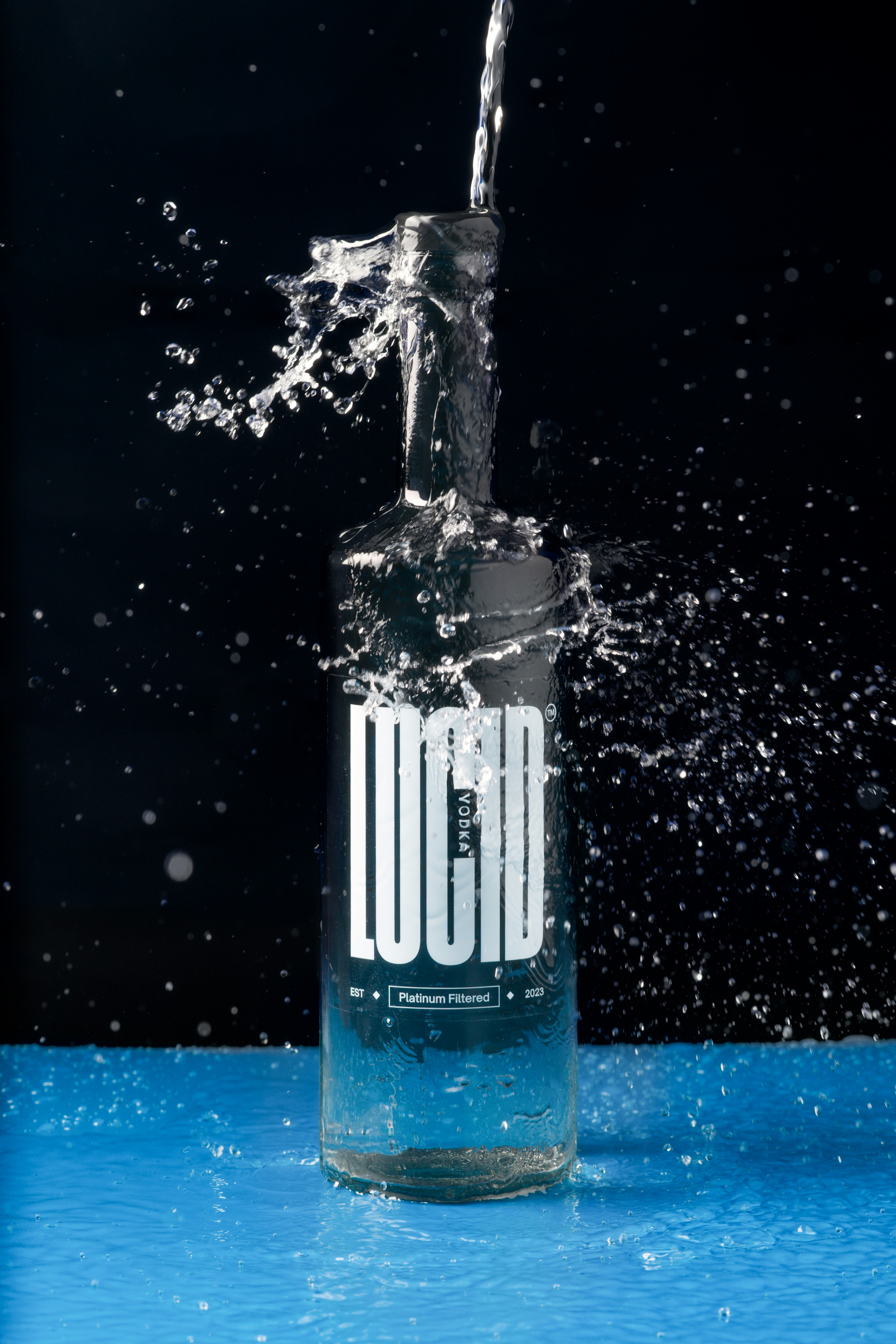 a bottle of liquid is being poured into the water