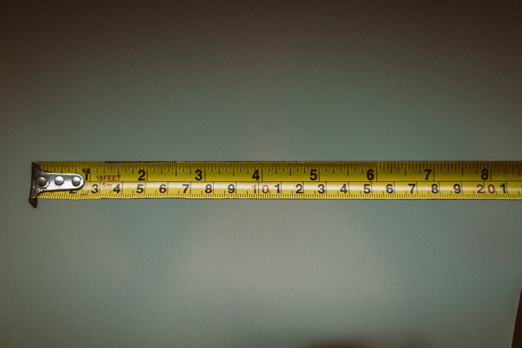 Person using a tape measure to plan an accurate repair or installation
