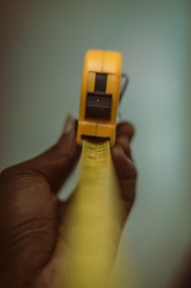 a person holding a yellow object in their hand