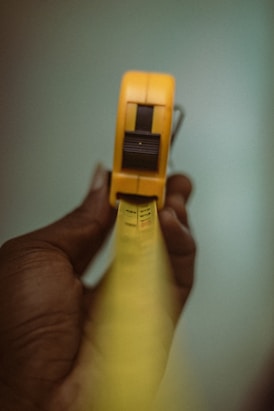 a person holding a yellow object in their hand