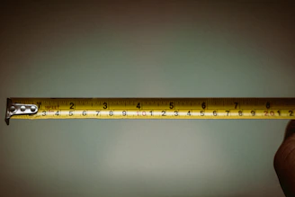 a person holding a measuring tape in their hand