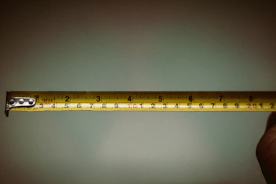 a person holding a measuring tape in their hand