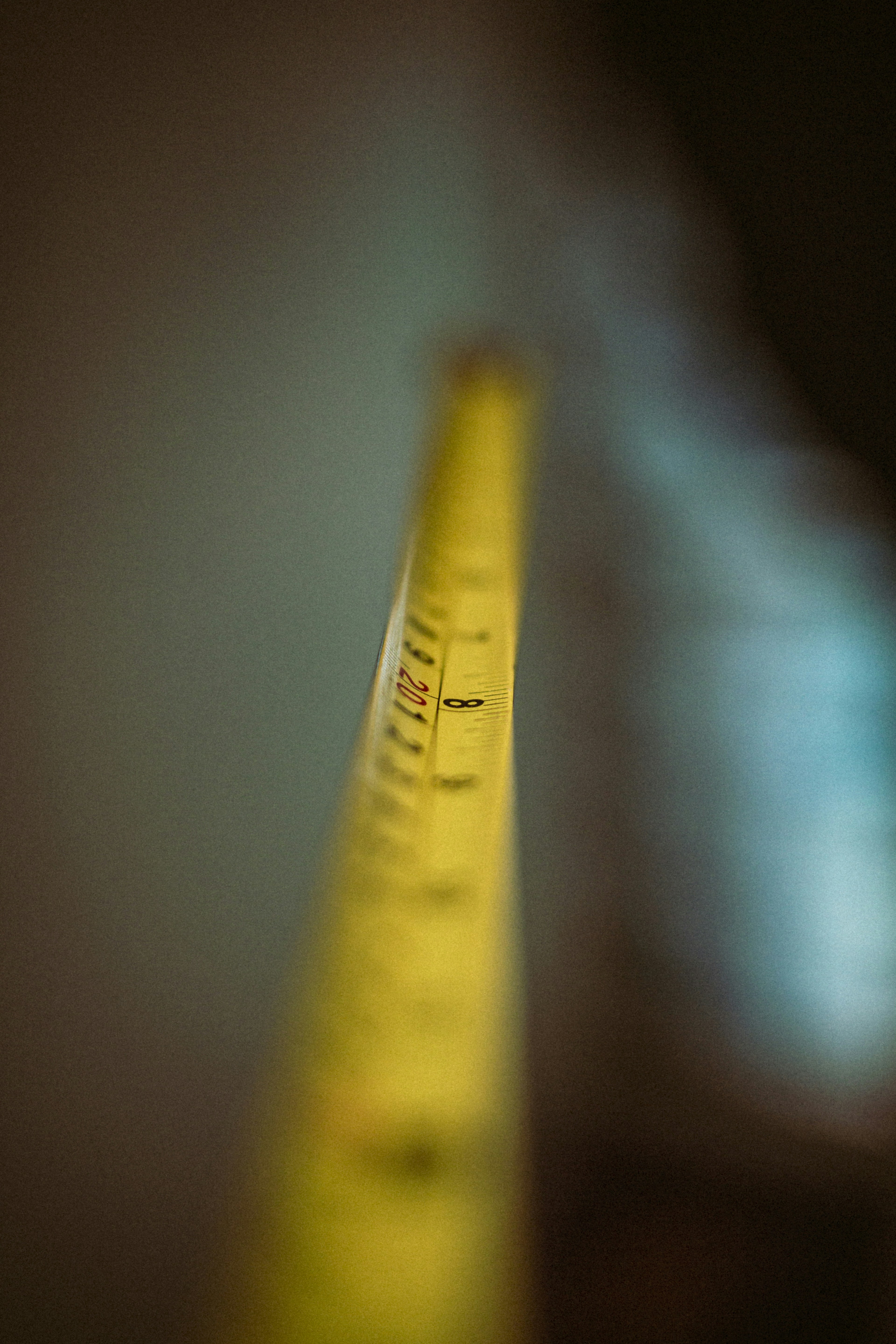 a close up of a yellow tape with a blurry background