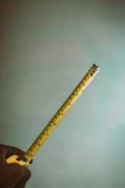 a person holding a measuring tape in their hand