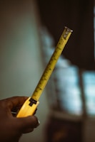 a person holding a tape measure in their hand