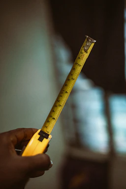 a person holding a tape measure in their hand