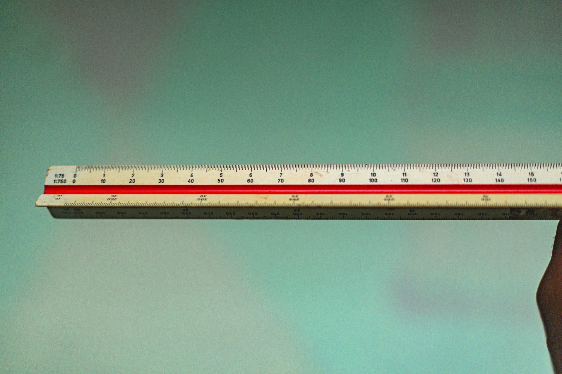 a person holding a ruler in their hand