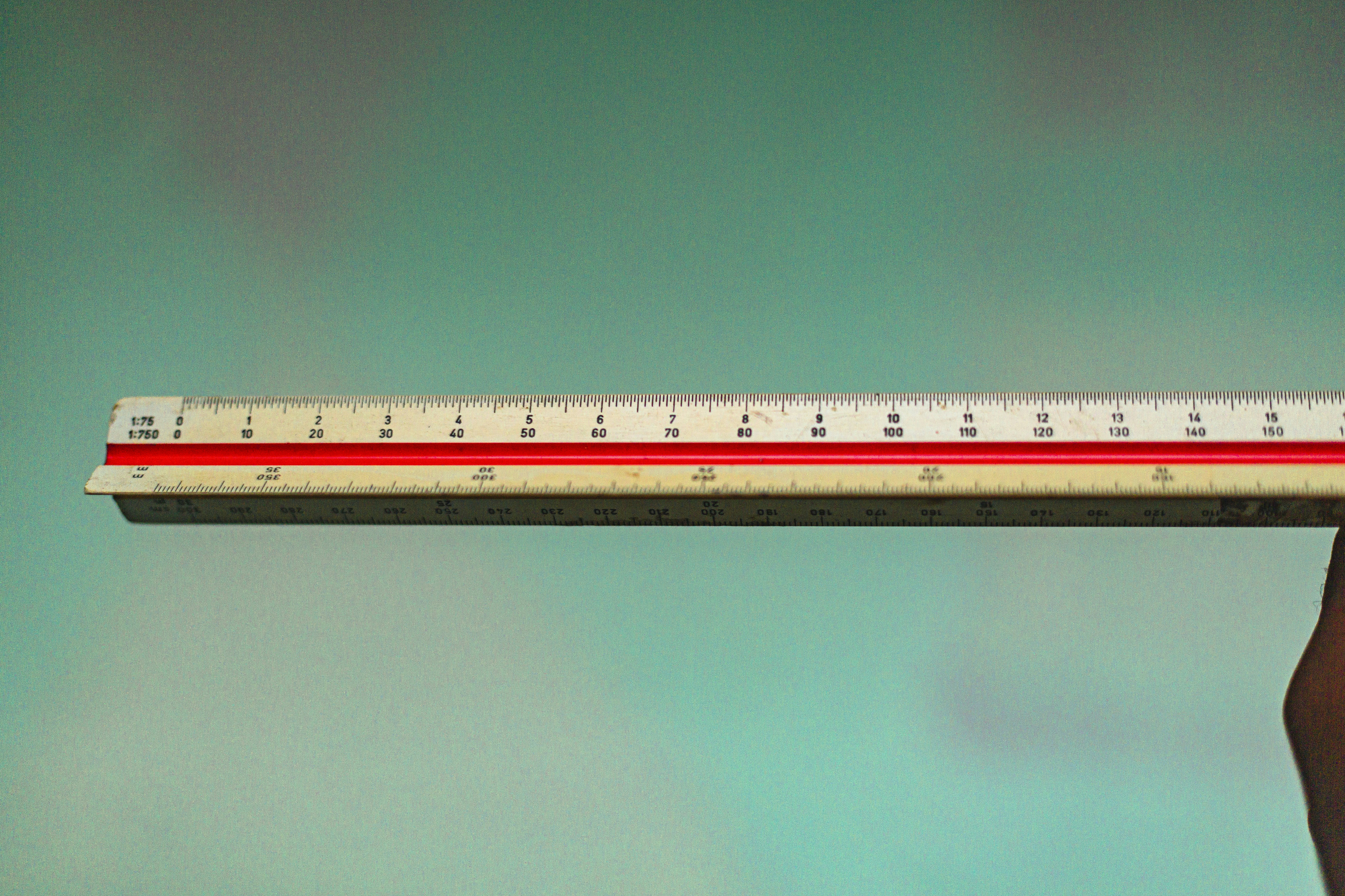 a person holding a ruler in their hand
