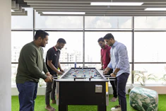 a group of men playing a game of foo - pong