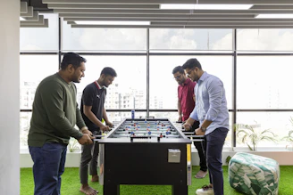 a group of men playing a game of foo - pong