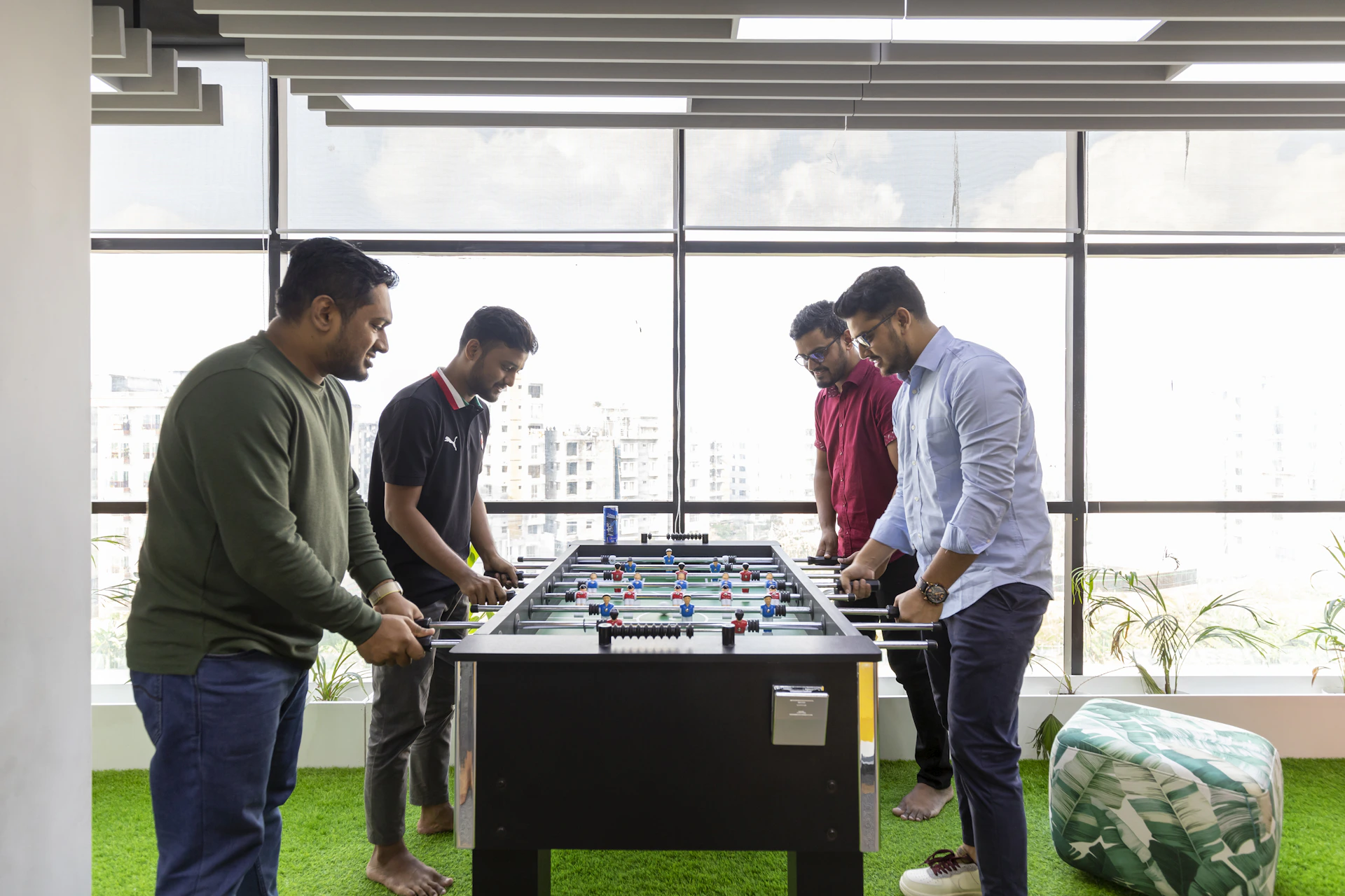 a group of men playing a game of foo - pong
