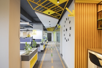 a long hallway with yellow and black accents