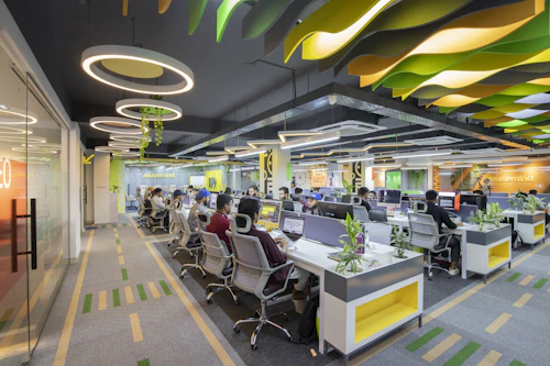 A large open-plan office floor with many desks, representing a full creative department.