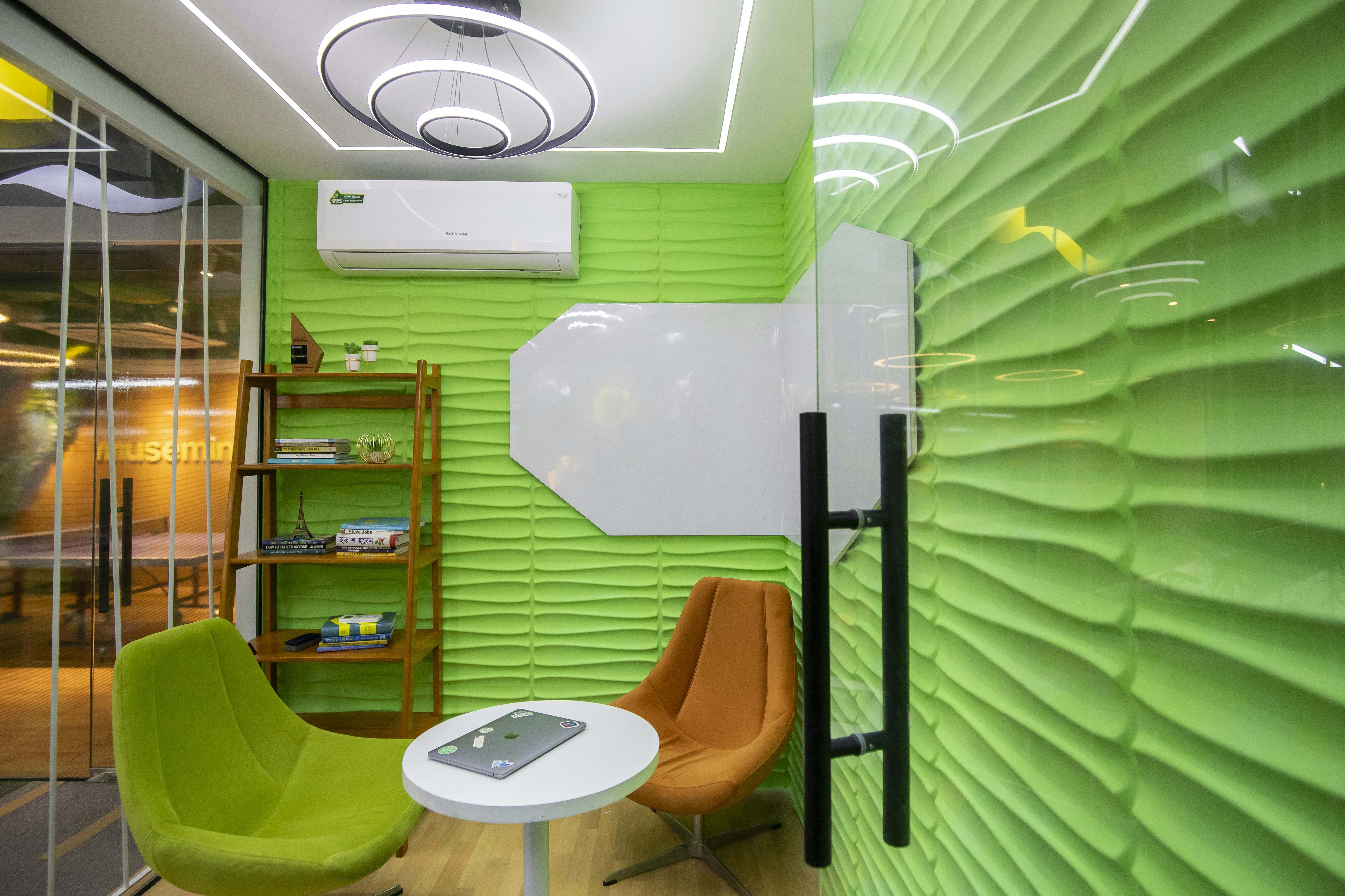 a room with a green wall and a white table