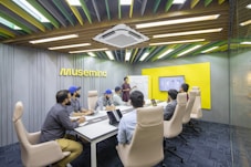 a group of people sitting around a conference table