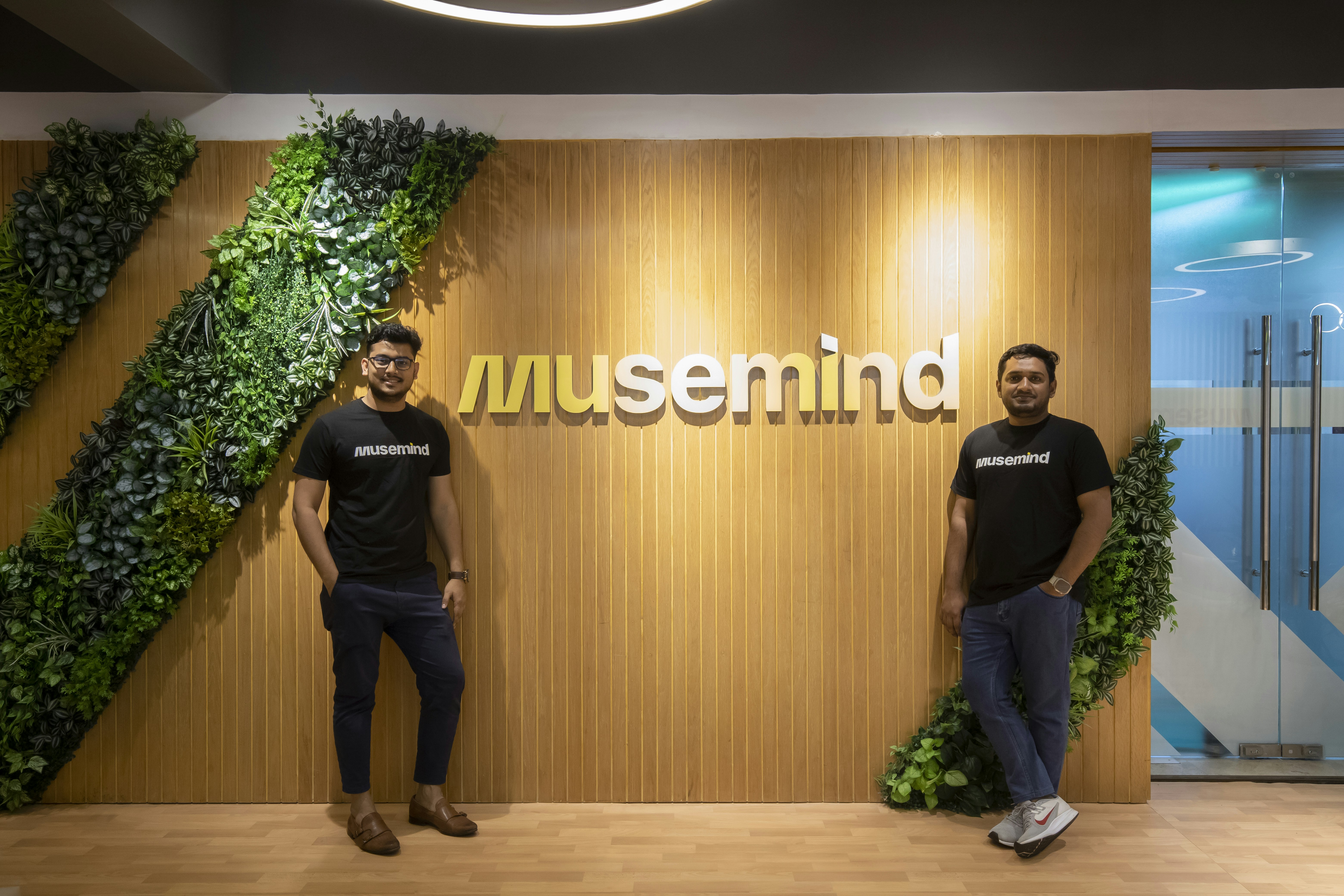 two men standing in front of a museum sign