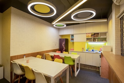 a room with a table, chairs, and a counter