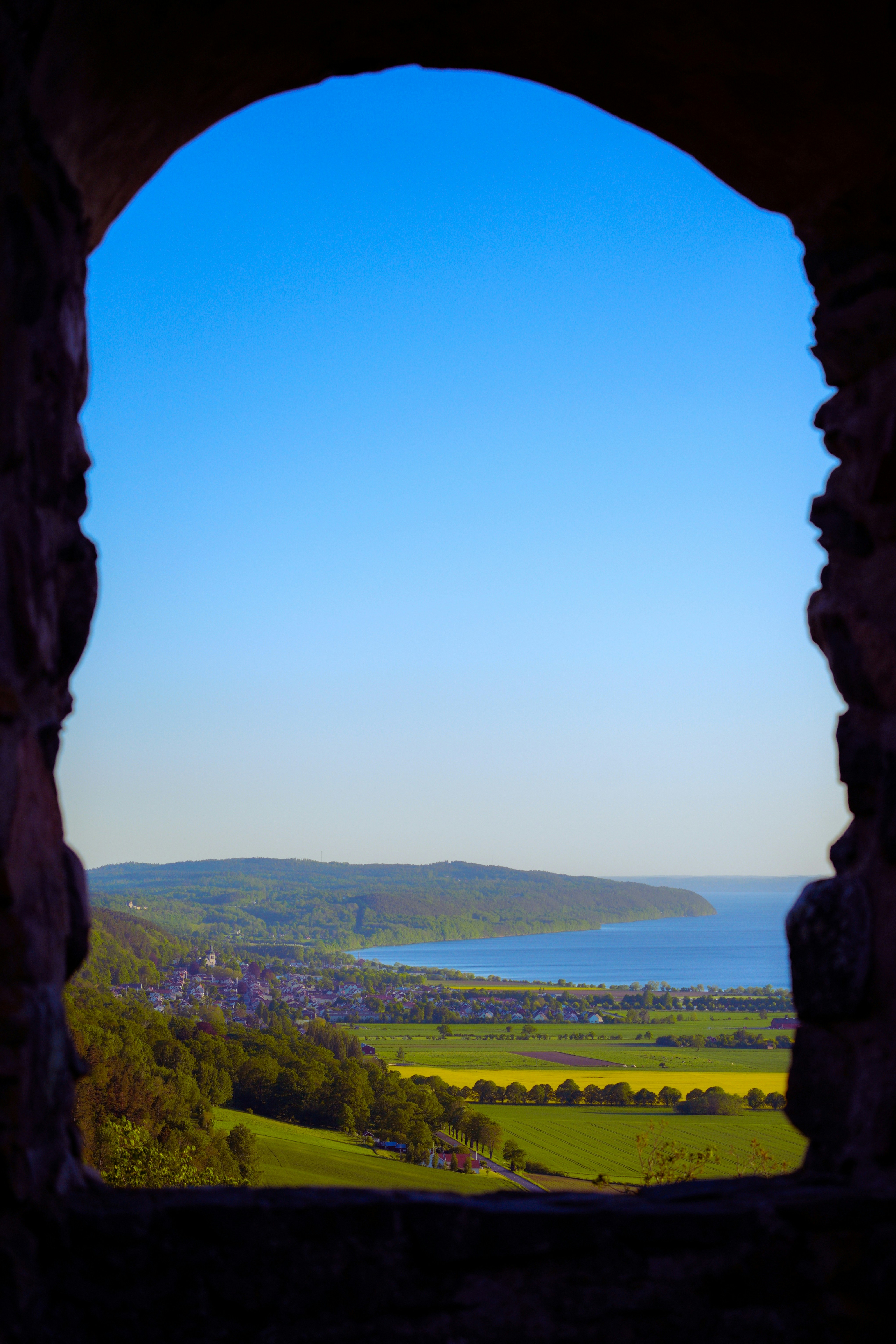 A view of a lake through a window photo – Free Blue Image on Unsplash