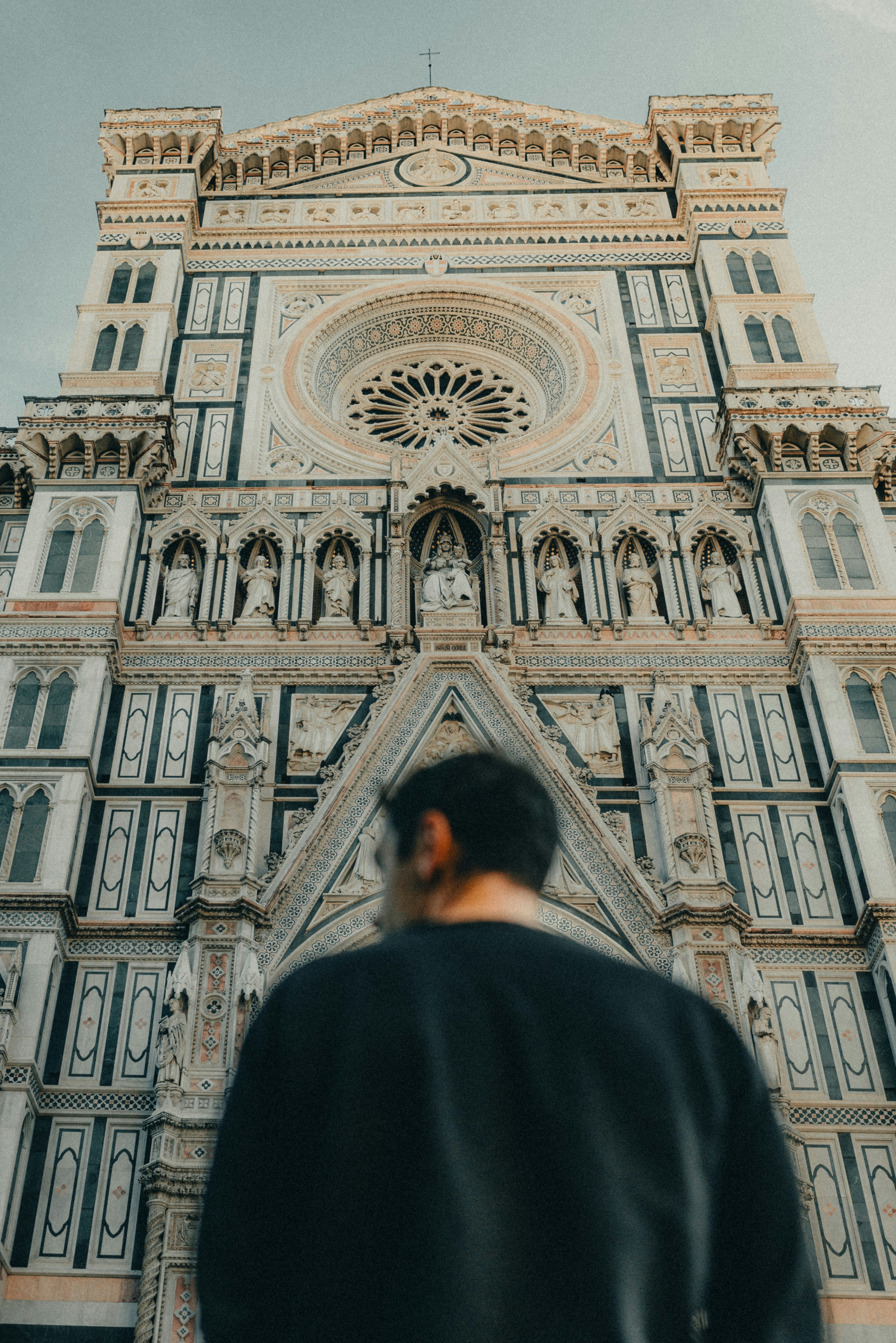 A man standing in front of a tall building photo – Free Firenze Image ...