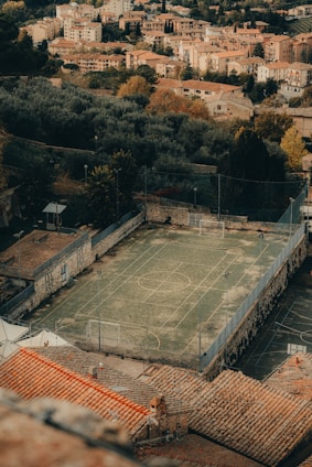 an aerial view of a tennis court in a city
