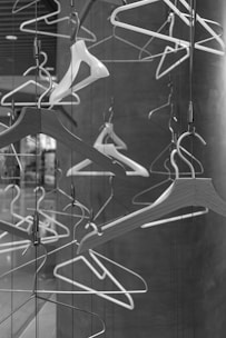 a black and white photo of clothes hangers
