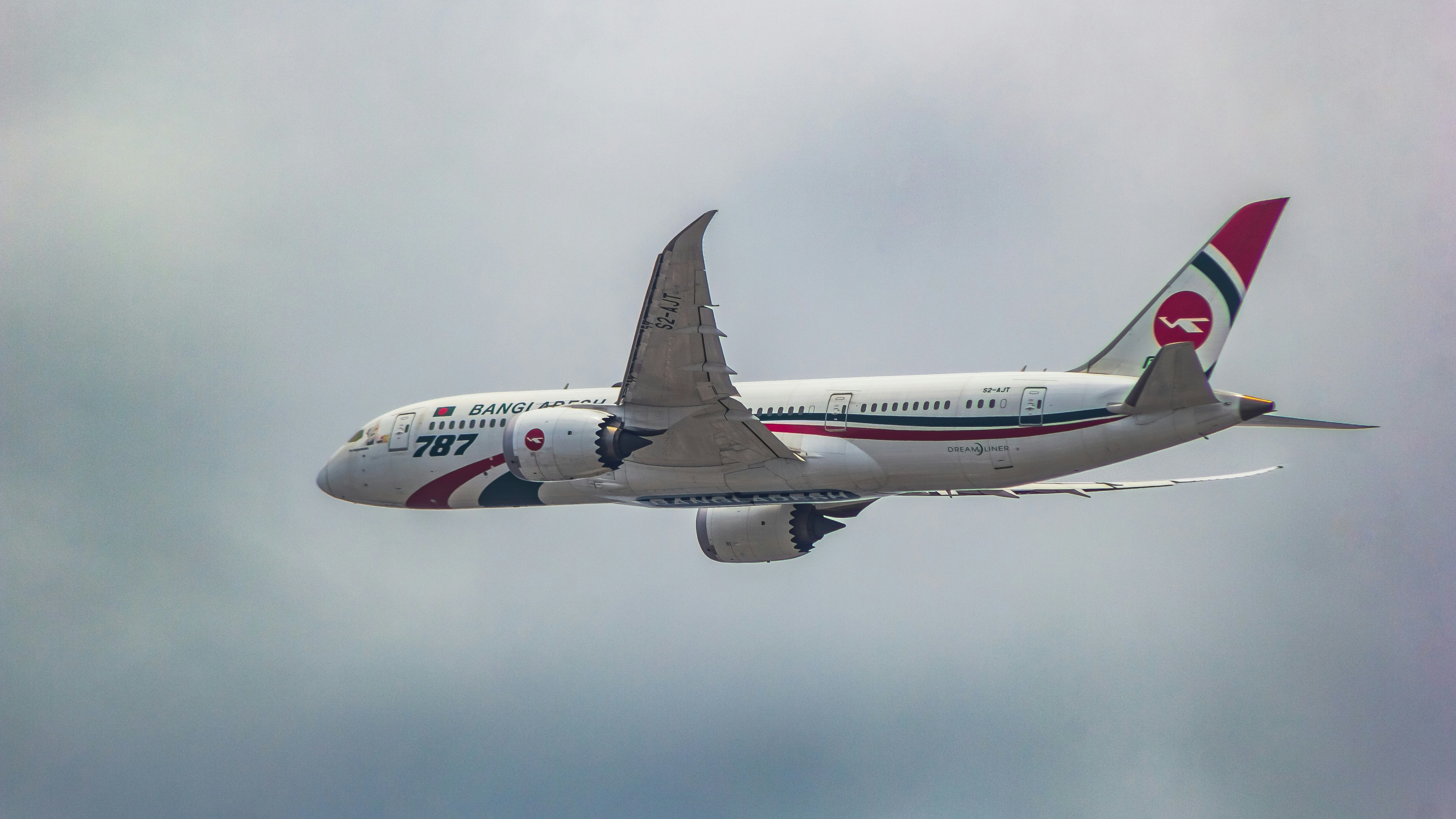 a large jetliner flying through a cloudy sky, Biman Bangladesh Airlines Hangsabalaka S2-AJT Boeing 787-8
