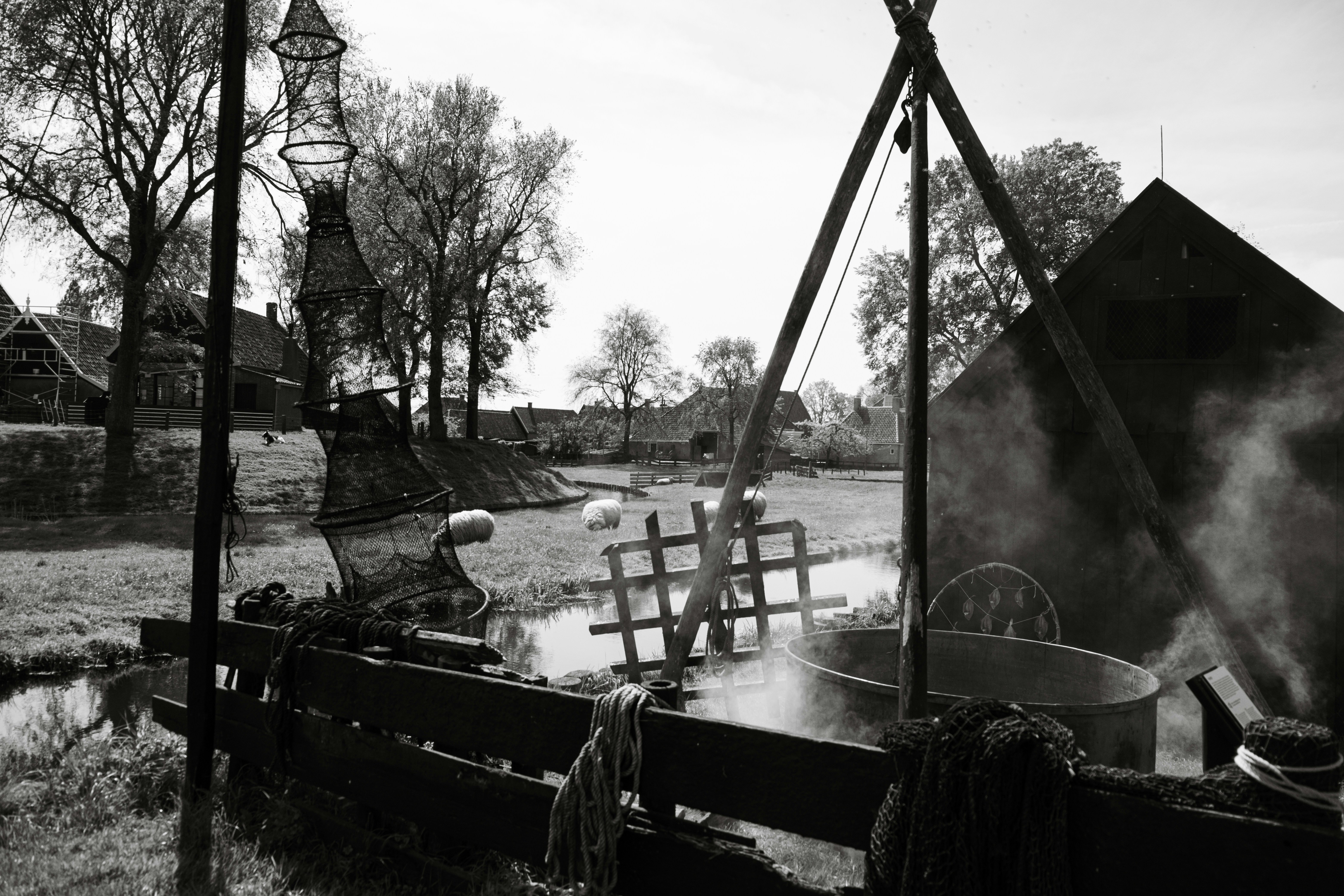 a black and white photo of a water wheel