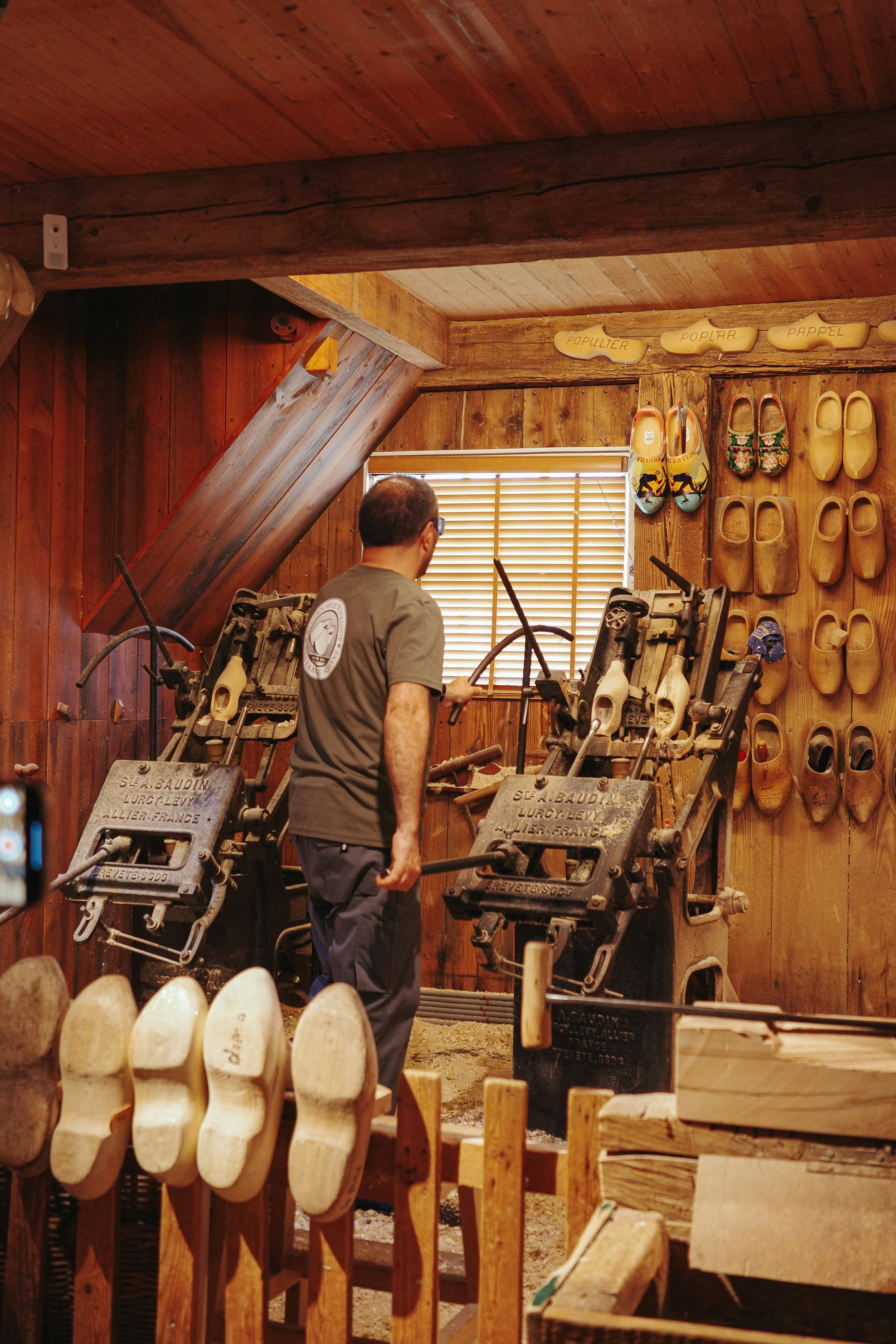 a man standing in a room filled with lots of shoes