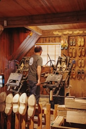 a man standing in a room filled with lots of shoes