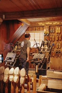 a man standing in a room filled with lots of shoes