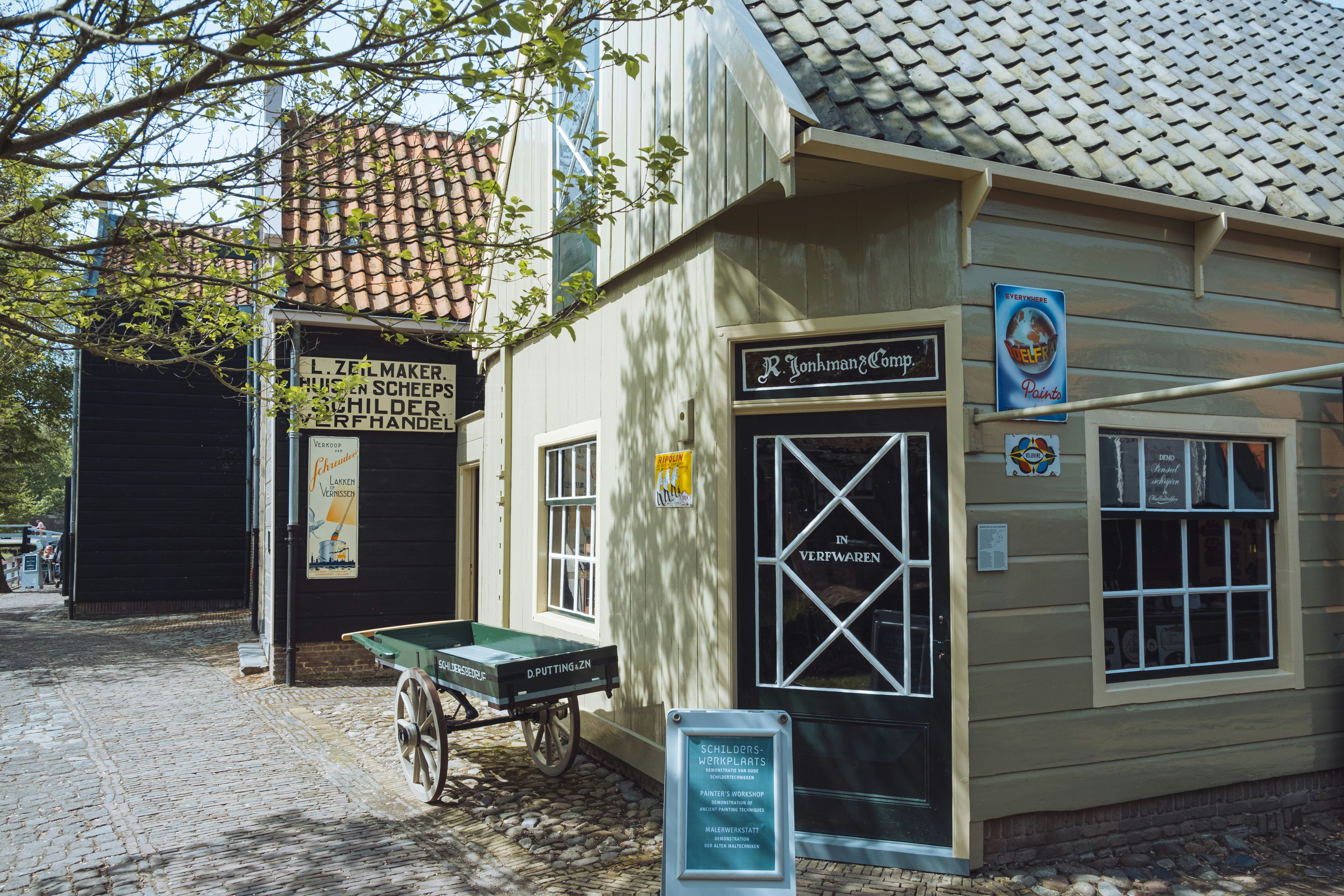a small building with a wagon in front of it