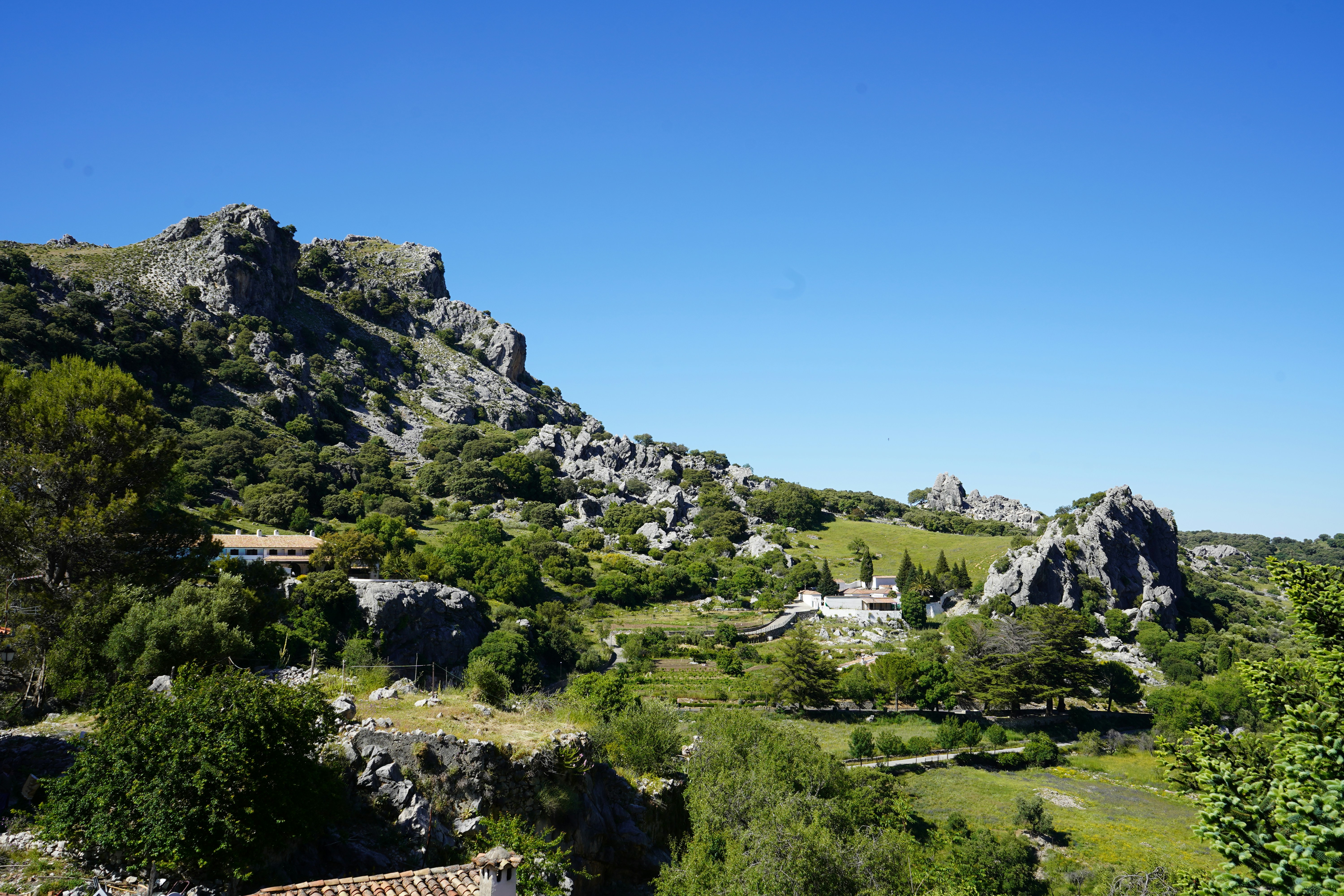 a view of a mountain with a house in the middle of it