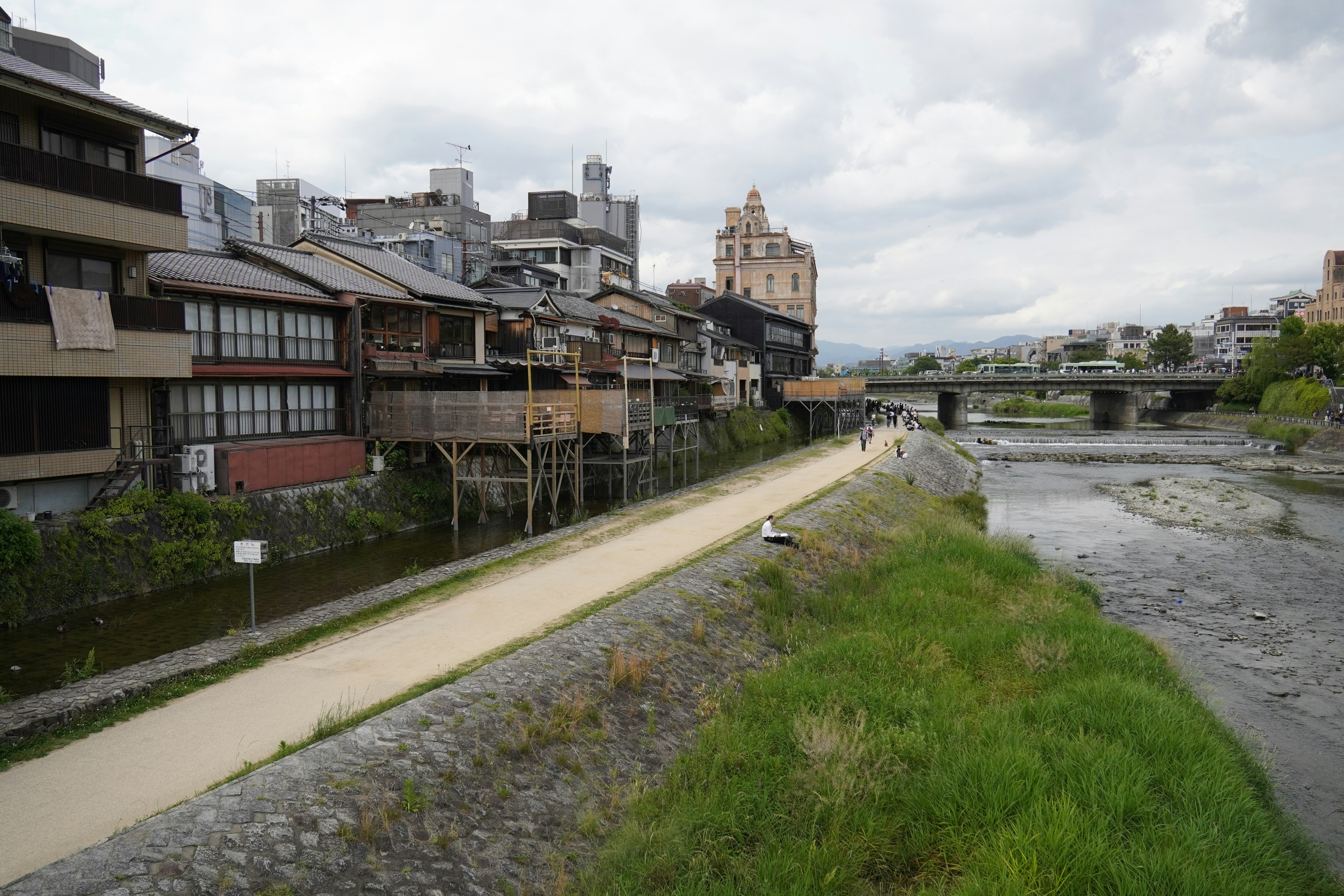 a river running through a city next to tall buildings