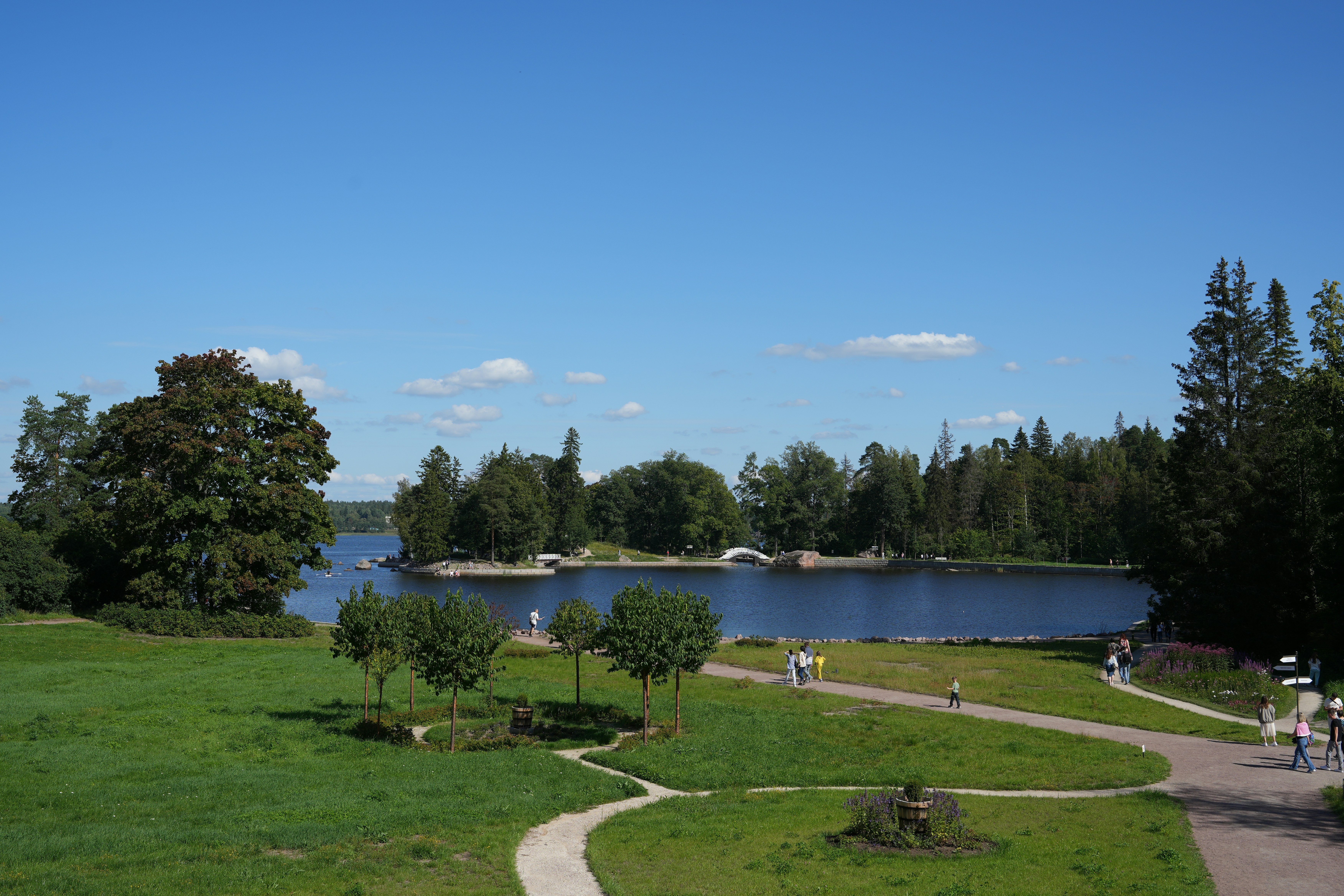 people walking on a path near a body of water