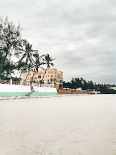 a white boat sitting on top of a sandy beach