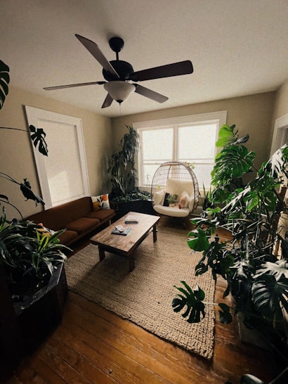 a living room filled with furniture and a ceiling fan