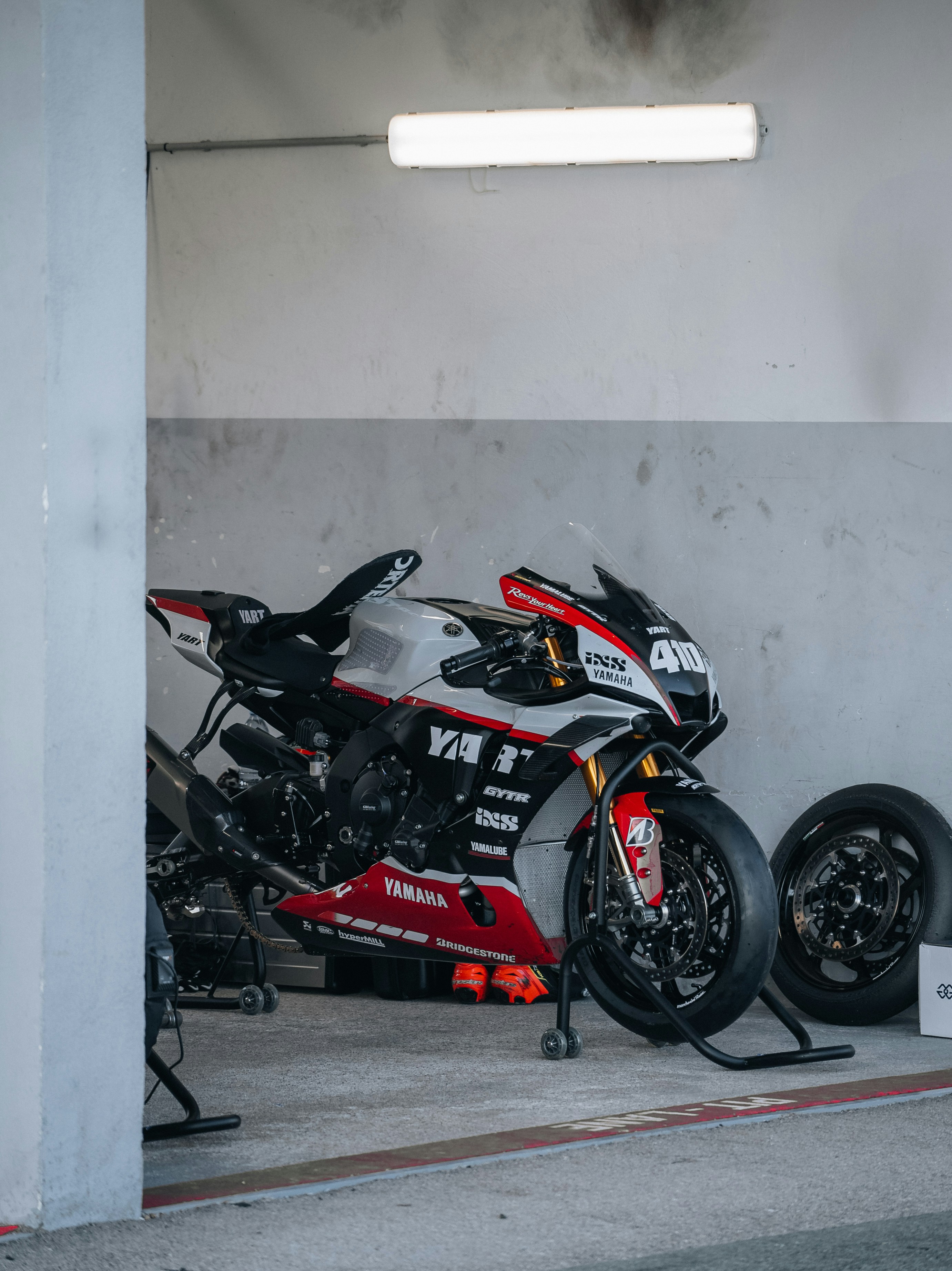 a motorcycle parked in a garage next to a wall