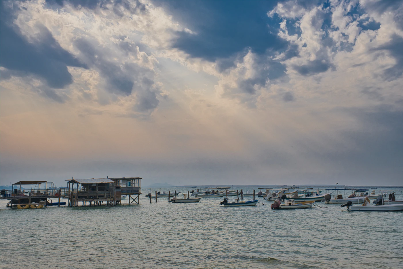 Fishing boats in calm water off Karbabad beach near Bahrain Fort