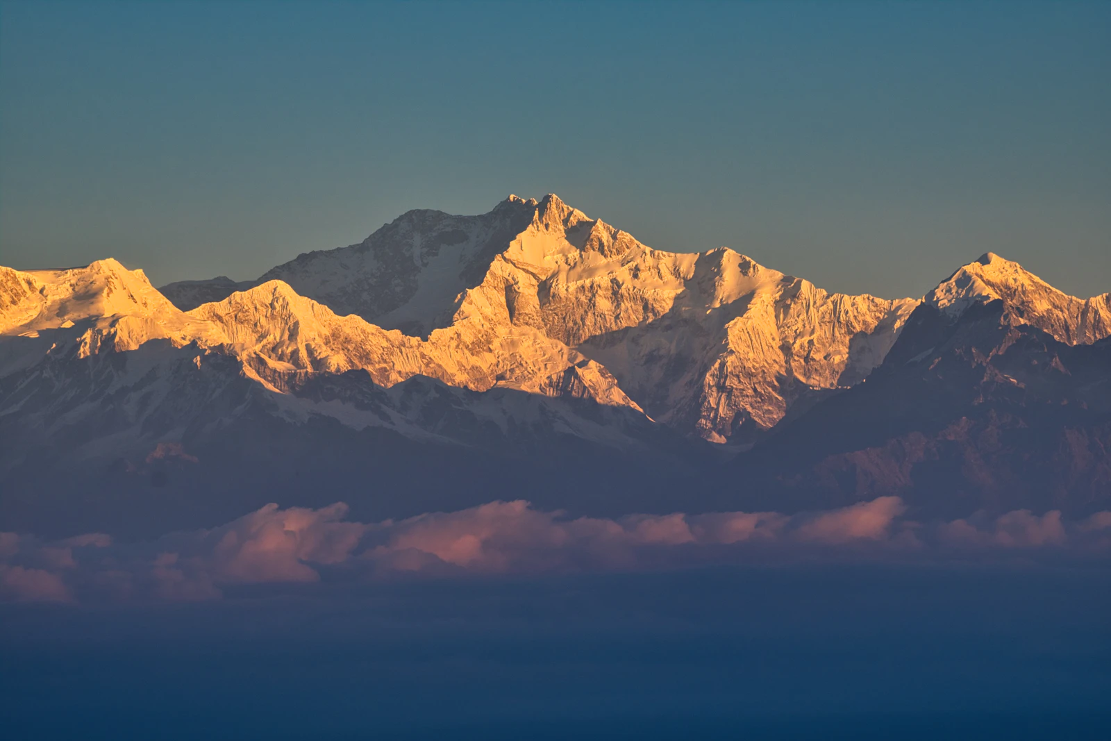 Kanchenjunga catching first light above a band of pink cloud, seen from Tiger Hill near Darjeeling