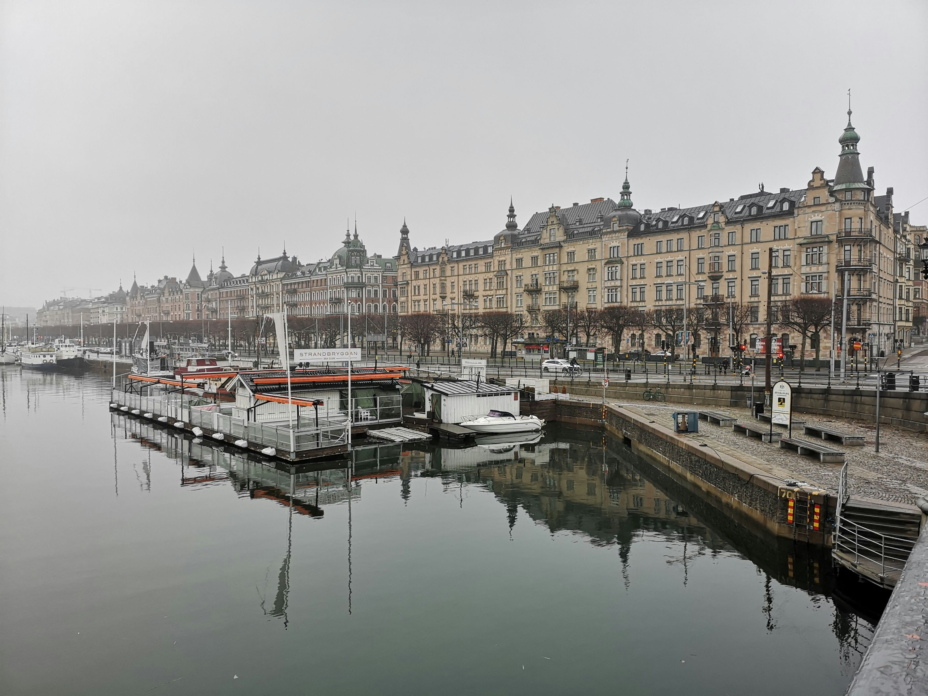 a harbor filled with lots of boats next to tall buildings