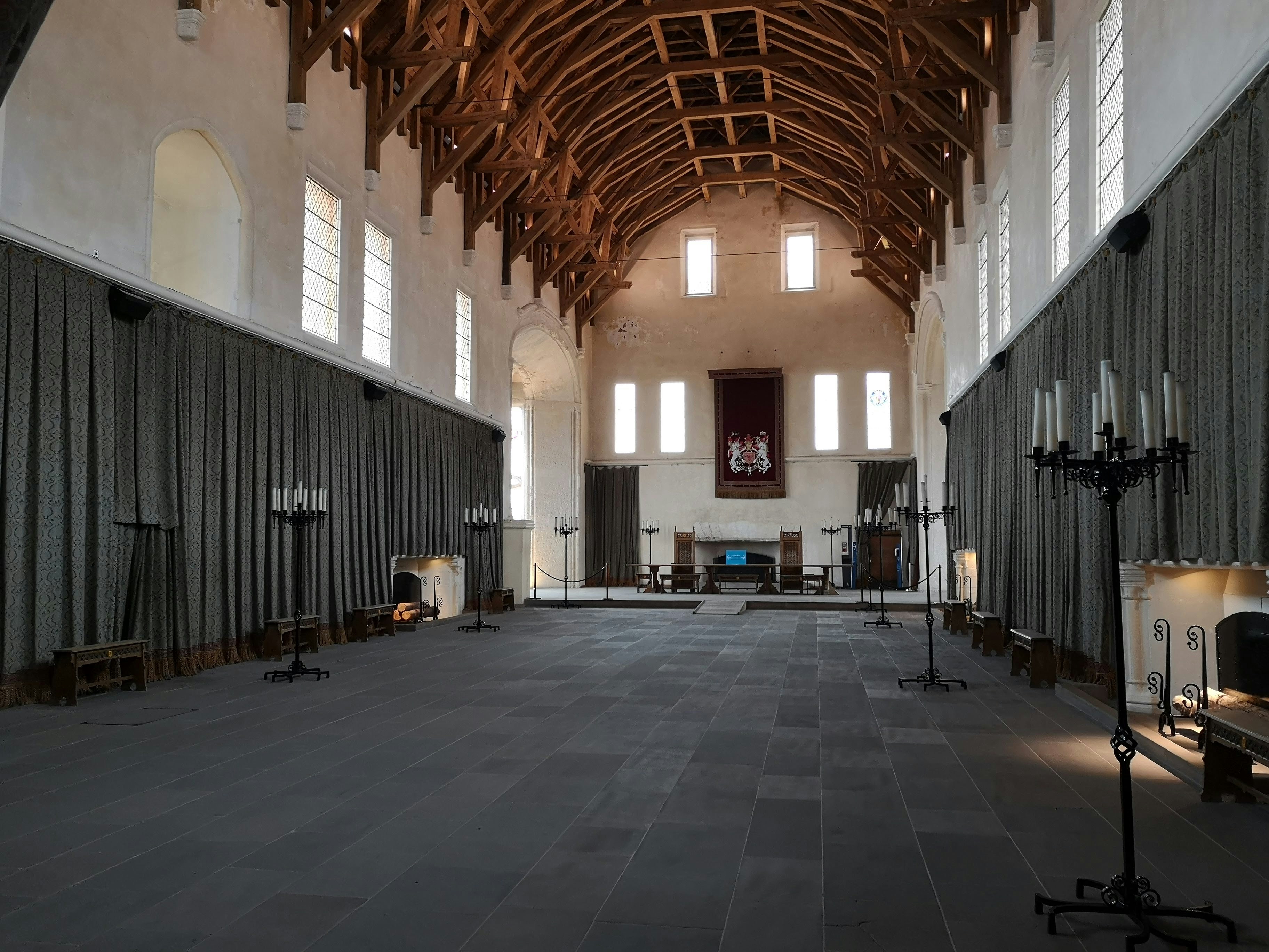 a large room with a wooden ceiling and windows