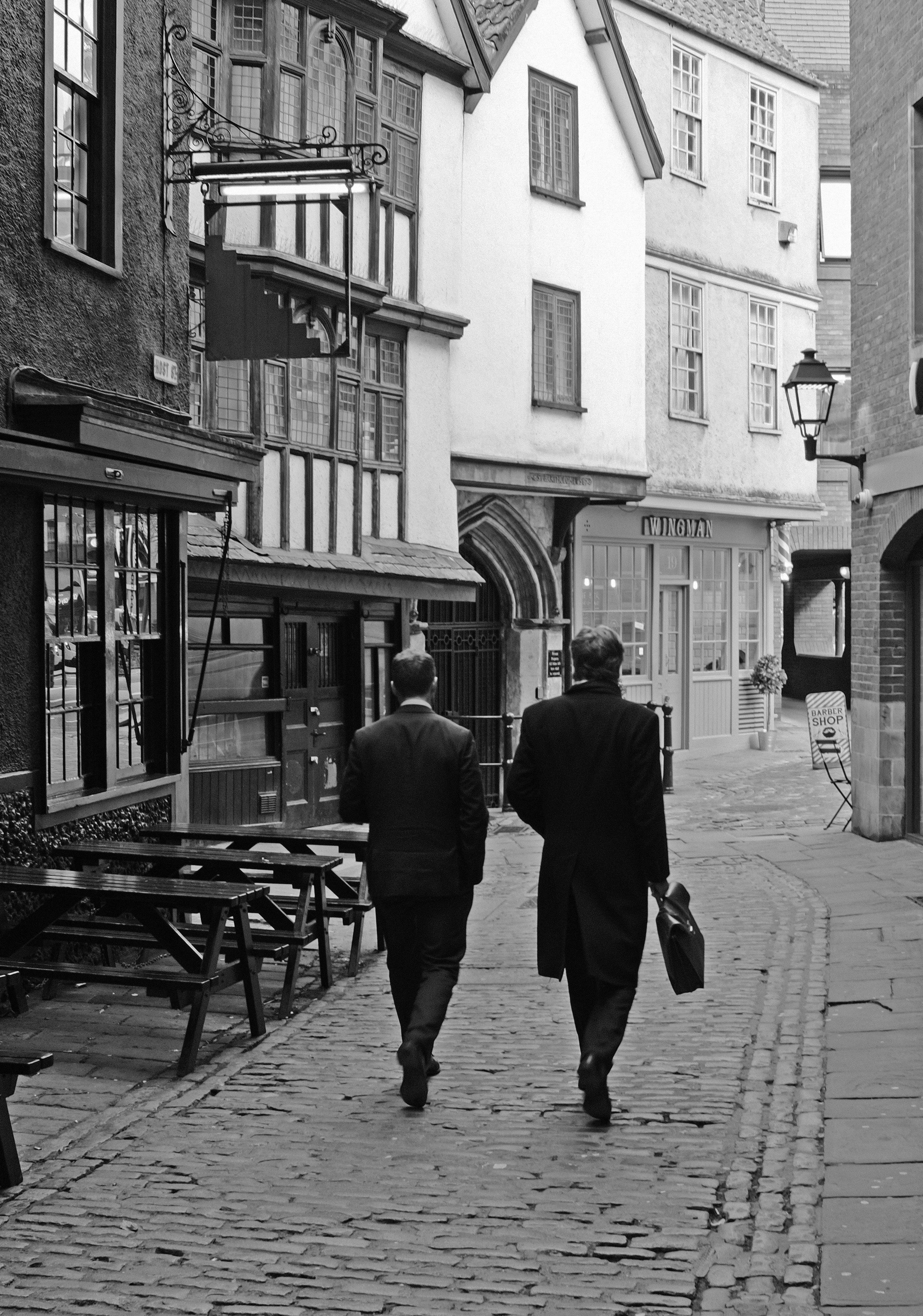 a couple of men walking down a street