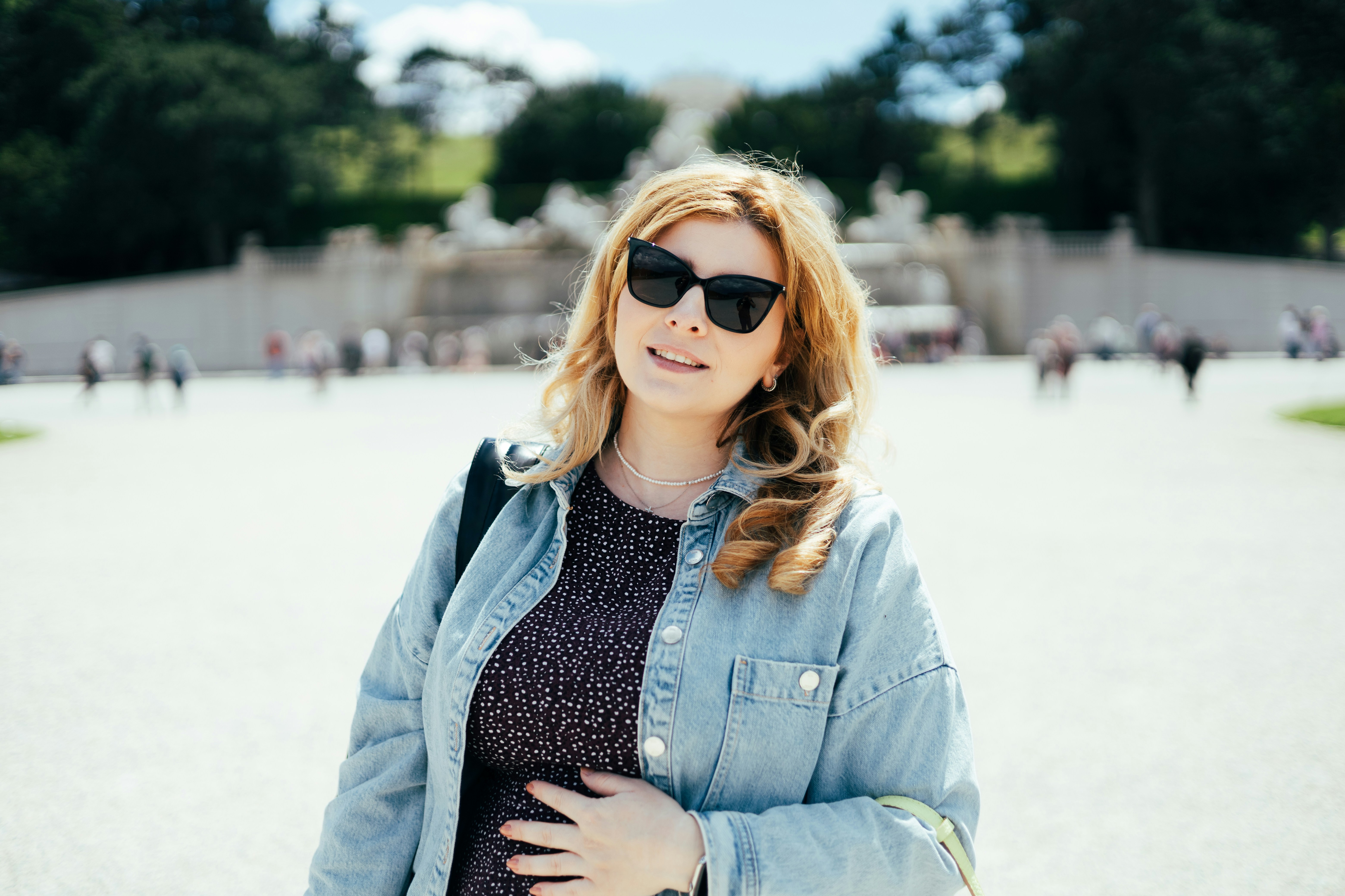 a woman wearing sunglasses and a denim jacket