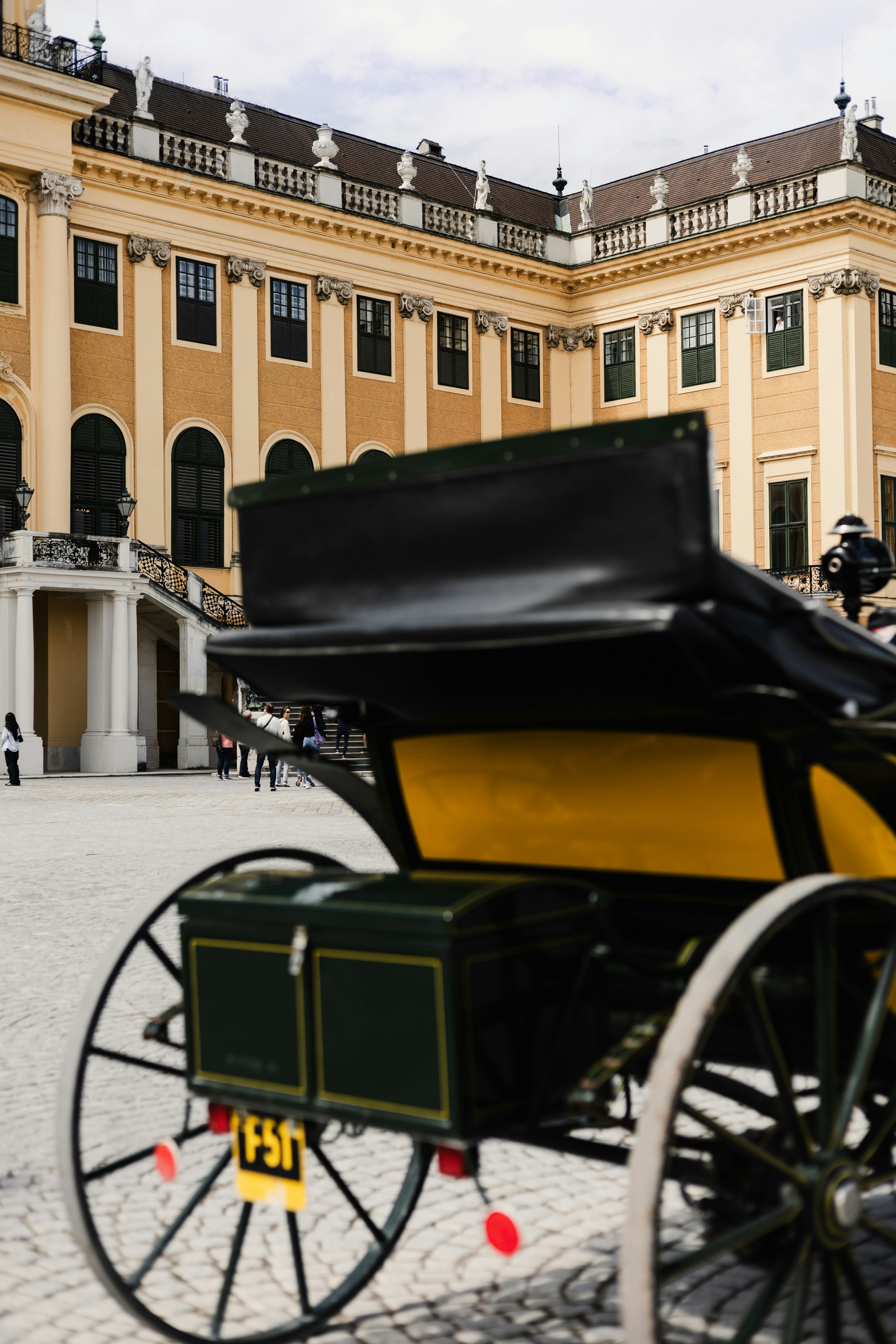 a horse drawn carriage parked in front of a large building