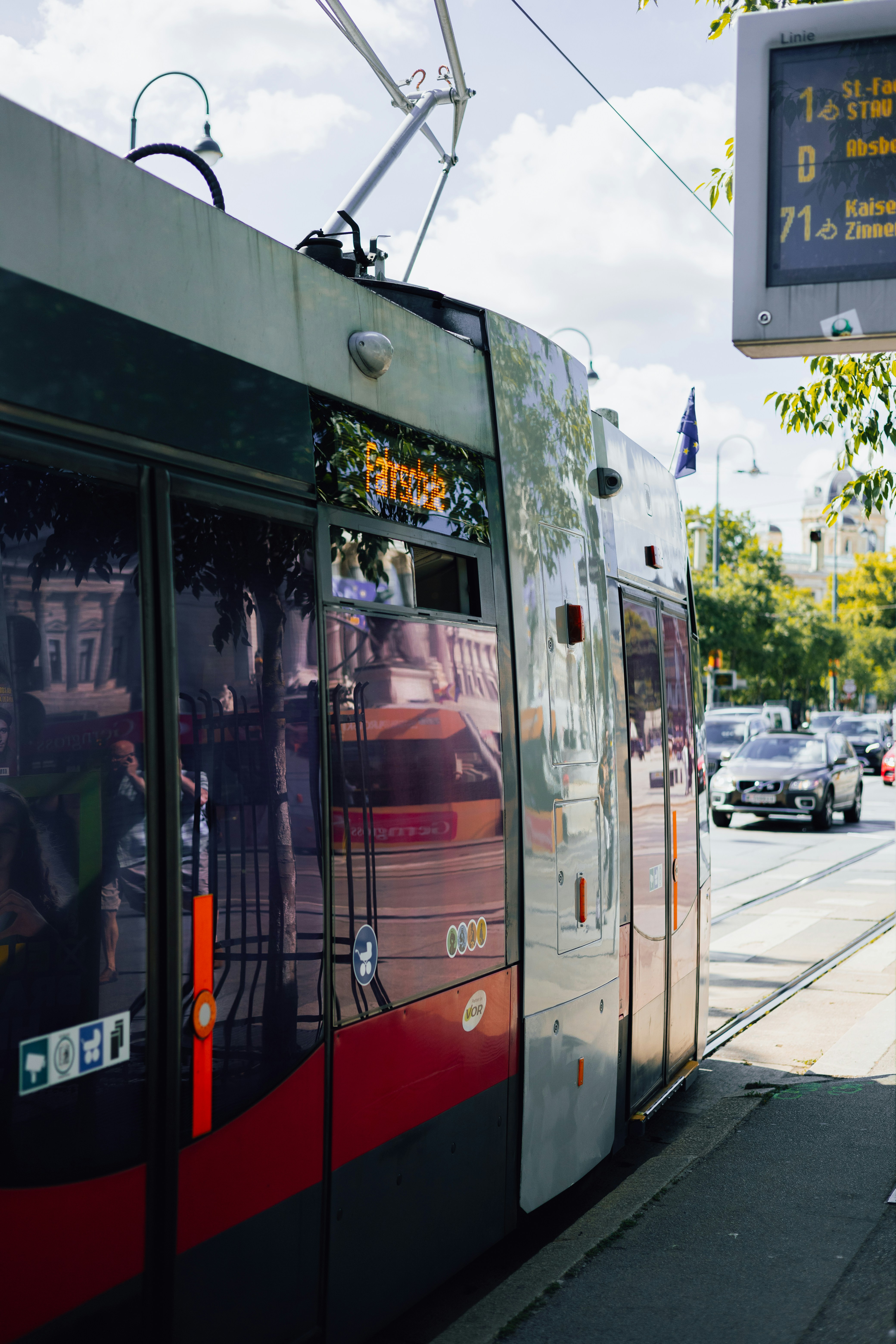a red and black train on a city street