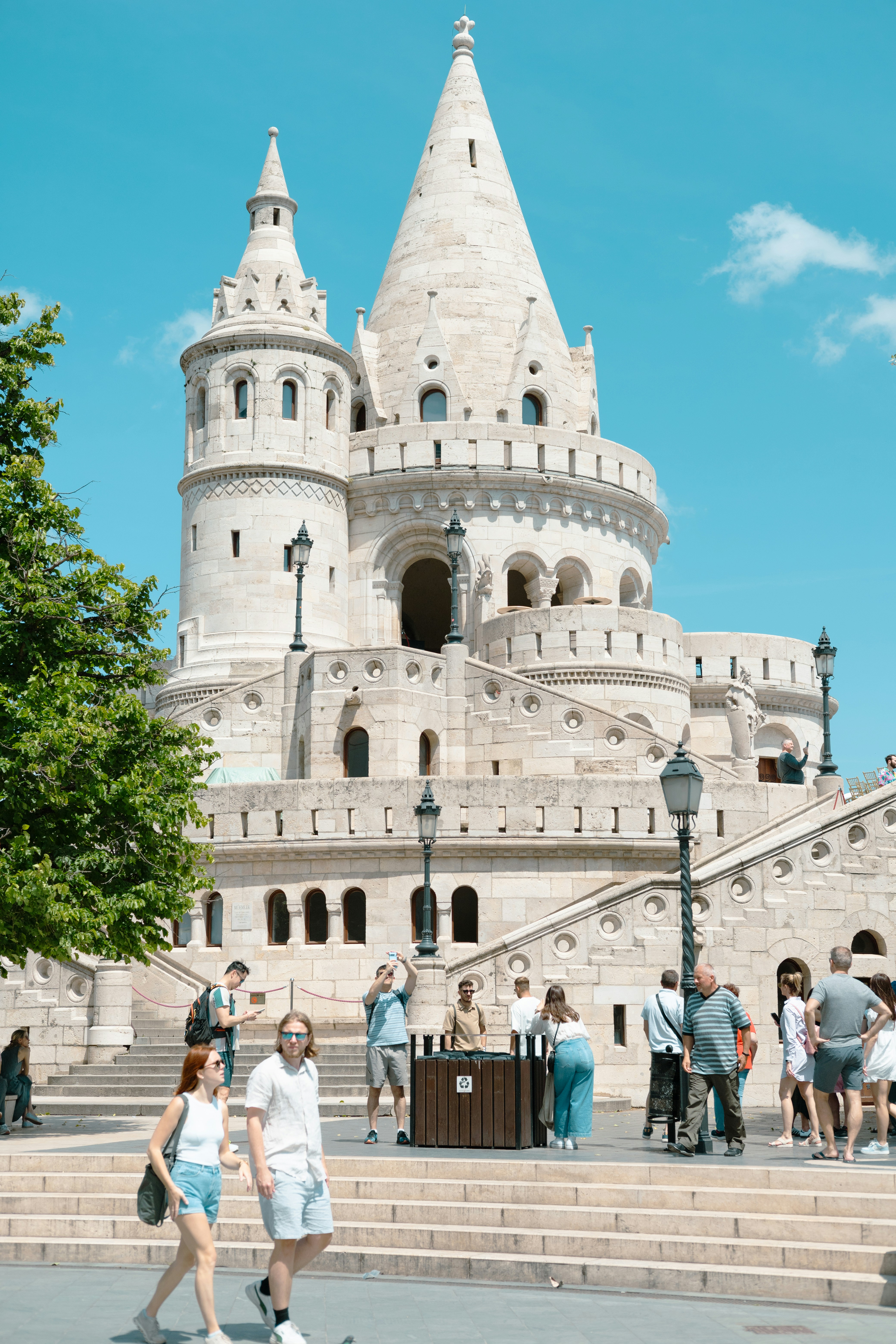 a couple of people that are walking in front of a castle