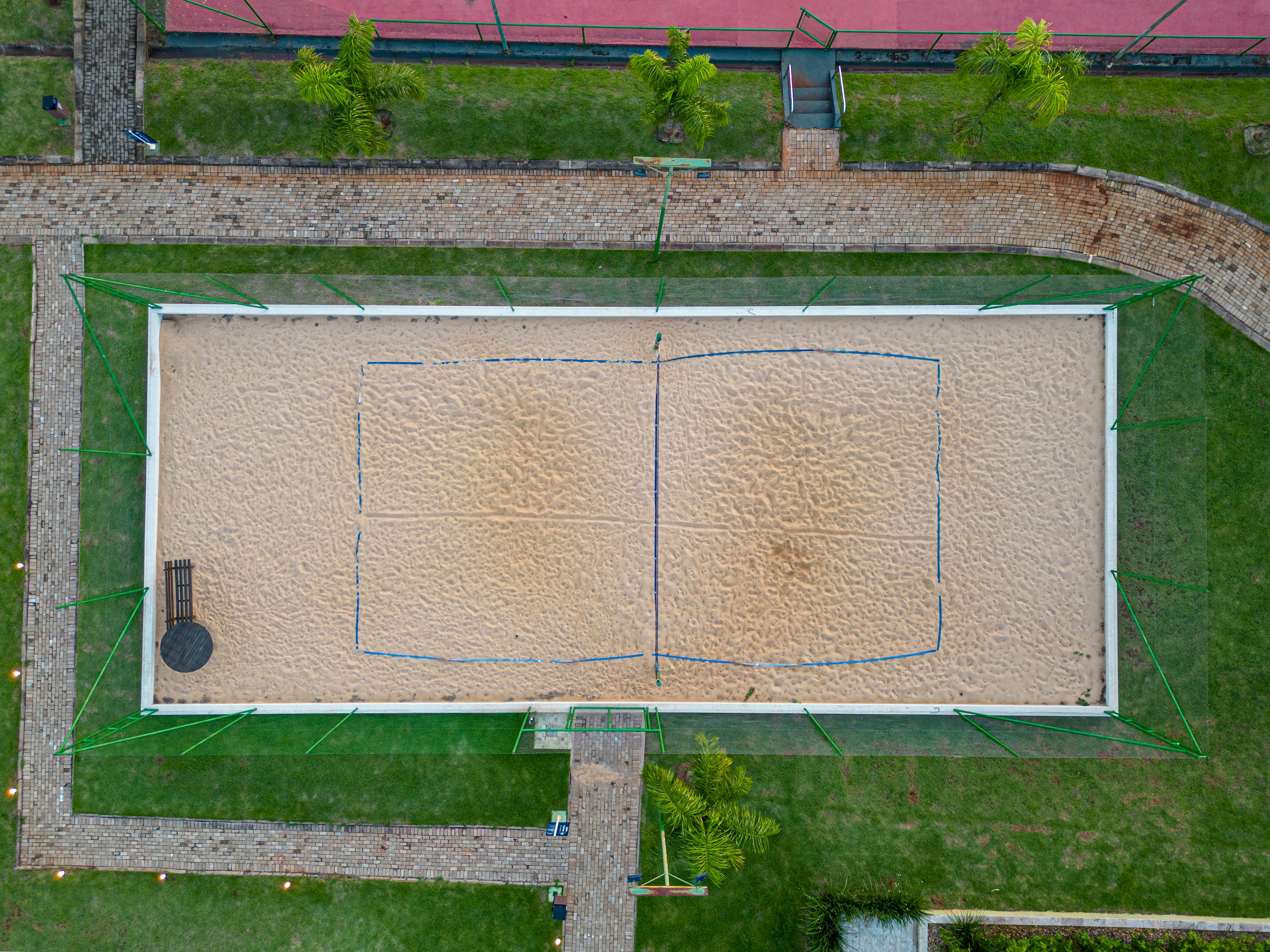 an aerial view of a basketball court in a park