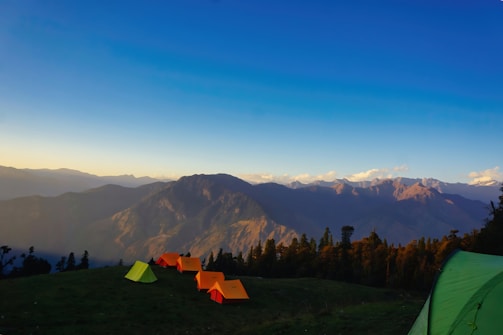 a group of tents pitched up on top of a mountain
