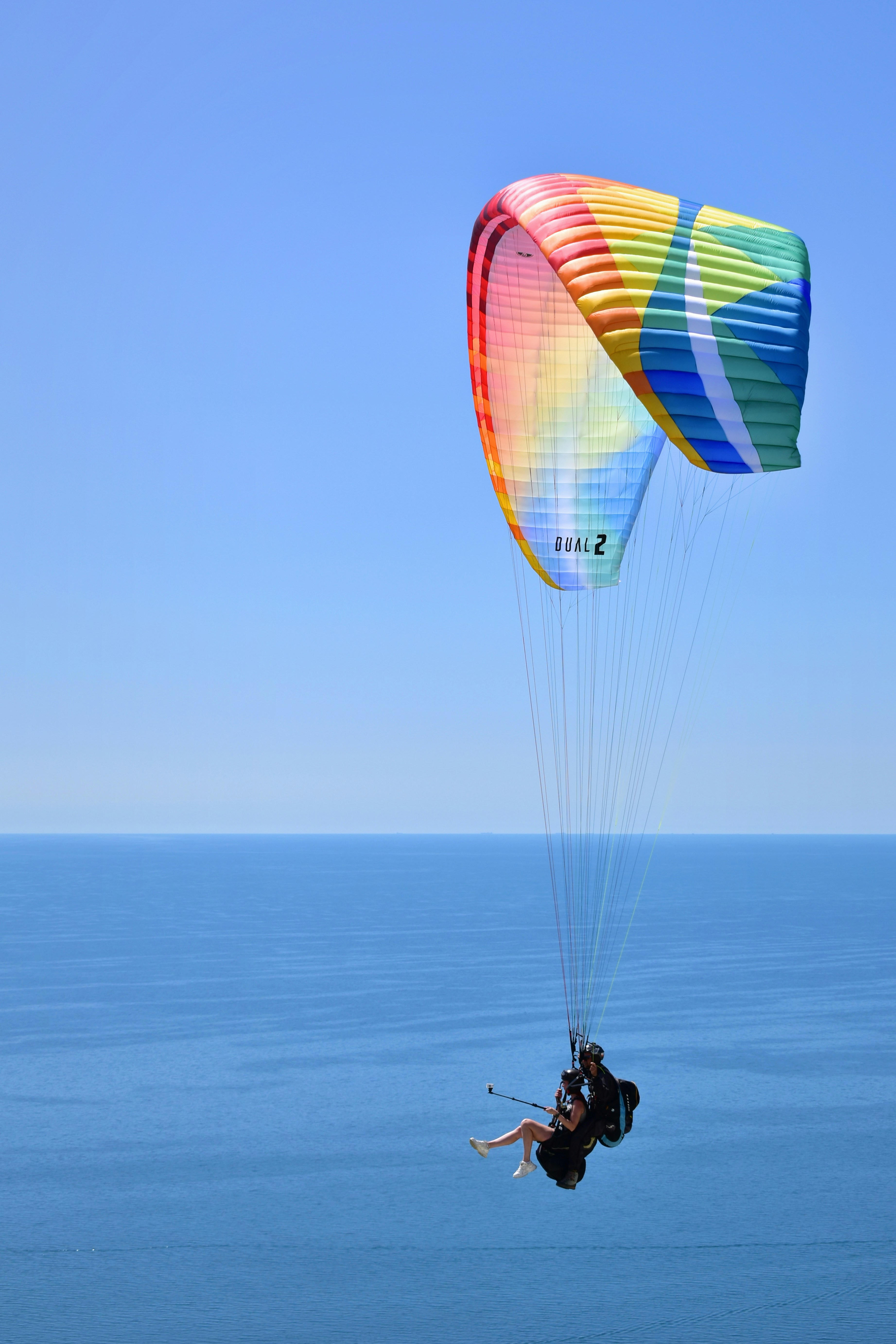 a person is parasailing over the ocean on a clear day