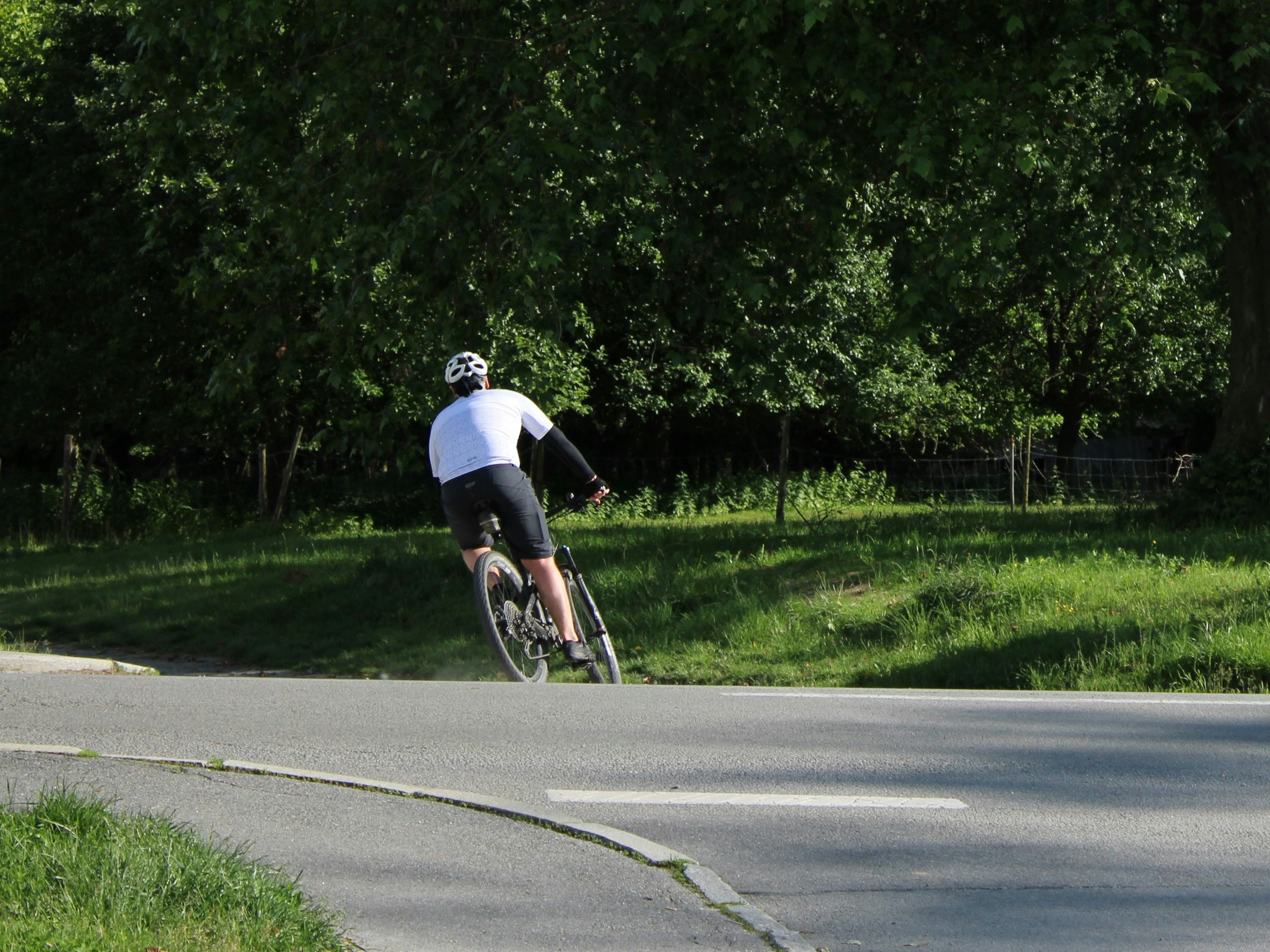 A man riding a bike down a curvy road